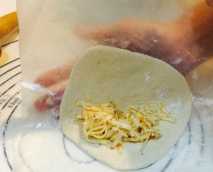 Fold dough using waxed paper.