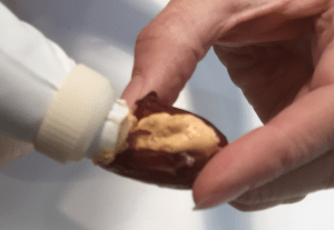 Hold open slit date and squeeze in filling.